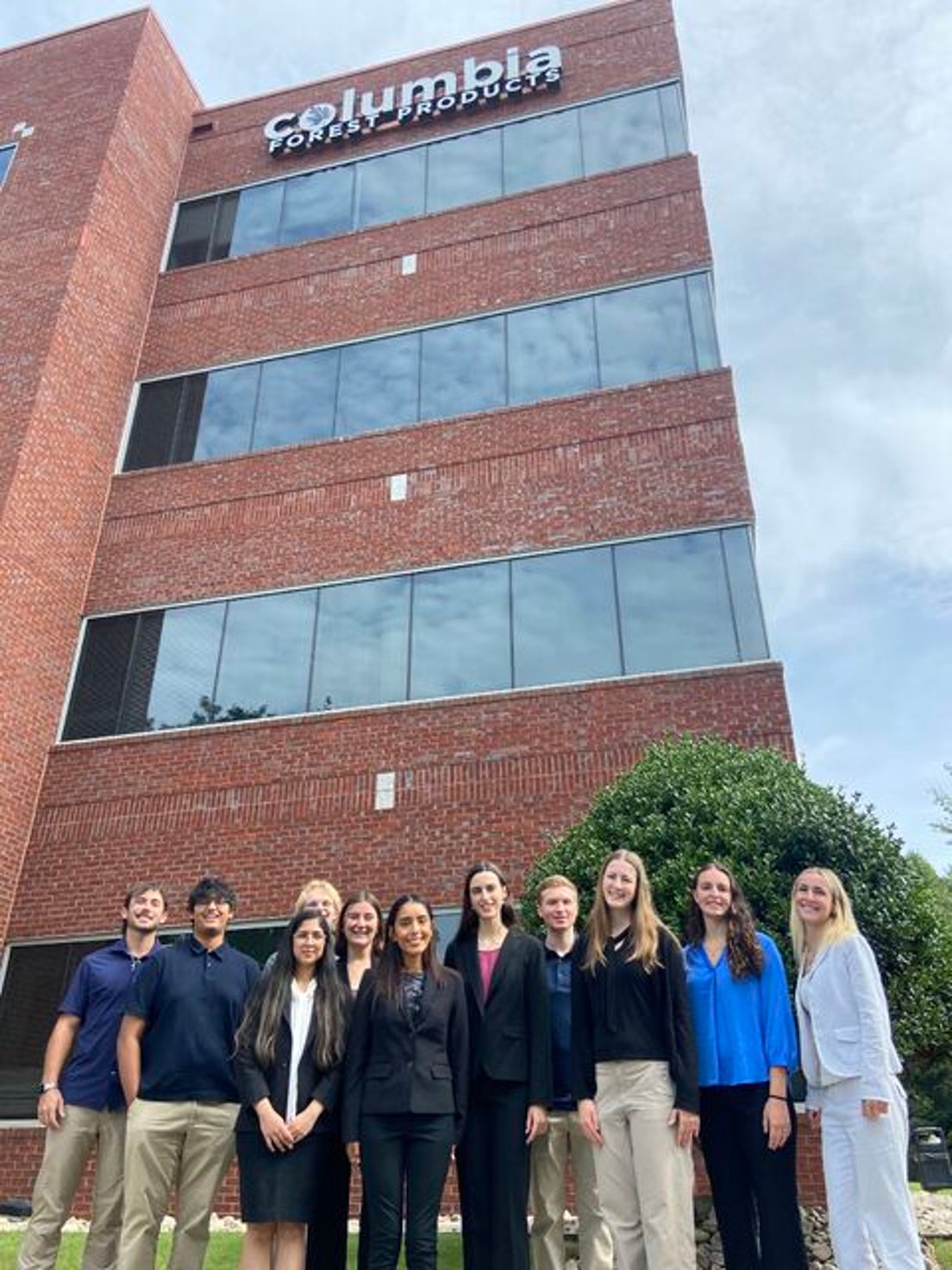 Interns in front of the Greensboro office building